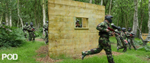 <A image of Paintball players in fog by a tree>